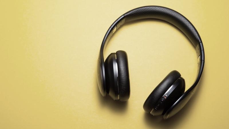 Wireless over-the-ear headphones on a yellow background